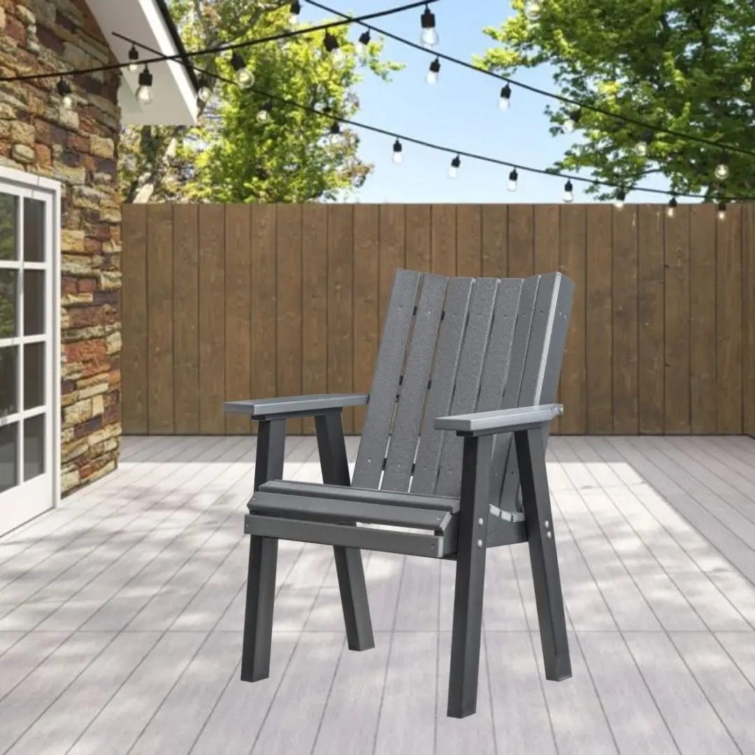 Gray Adirondack-style chair on a light wooden deck with string lights overhead and a wooden privacy fence behind it.